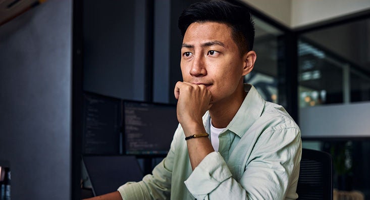Lifestyle image of person looking at desktop computer