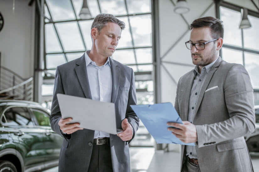 Photo of two car salesmen