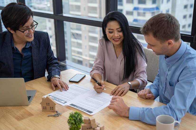Photo of coworkers going over papers in a skyrise
