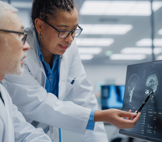 Health professionals examining a brain scan