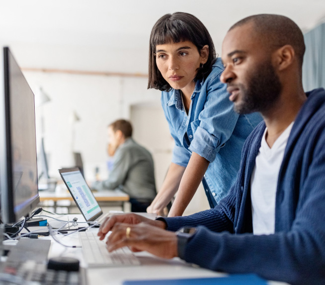 Active directory overview - two coworkers looking at computer lifestyle image