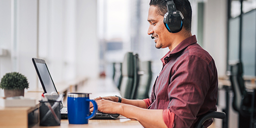 Lifestyle image of man with headset and coffee